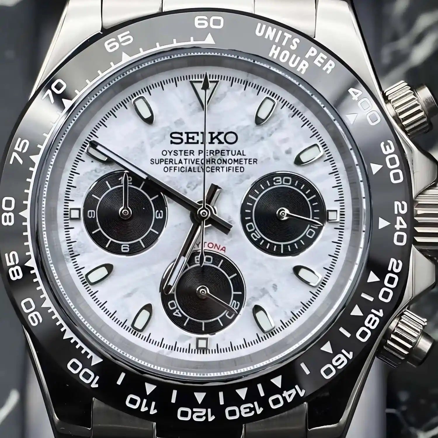 Close up of the Seiko Mod Daytona Meteorite. Watch with genuine meteorite dial, black totalizers, and engraved tachymeter bezel. Precise Seiko Mod design inspired by the Daytona
