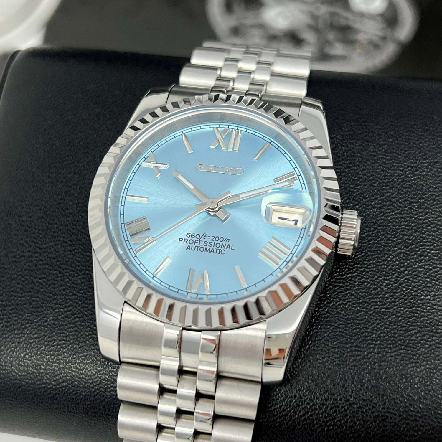 Seiko Mod Ice Blue Roman on display pillow with shiny case and jubilee bracelet