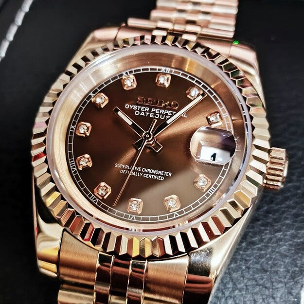 Close up of Seiko Mod Datejust in rose gold with chocolate dial and crystal hour markers