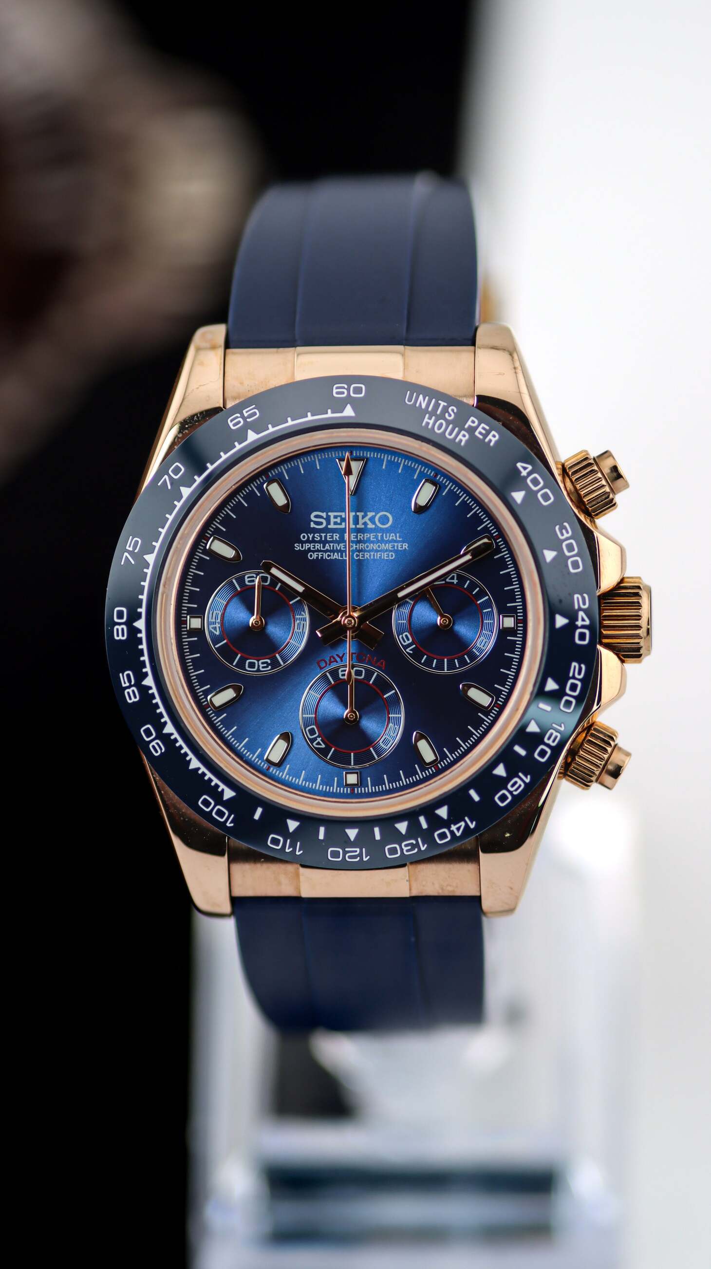 Seiko Mod Daytona Royal Blue front view with sunburst dial, rose gold case and navy rubber strap.