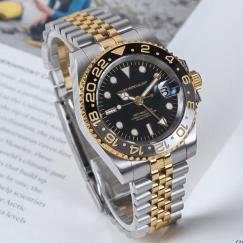 Angled left view Seiko Mod GMT two tone on magazine showing black dial and gold bezel