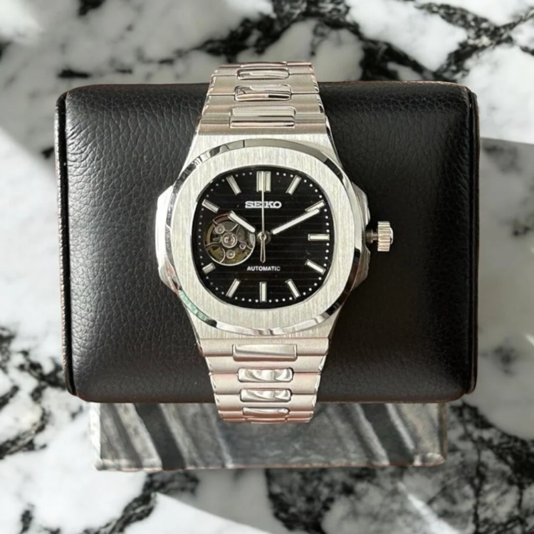 Seiko mod Nautilus black open heart front view on marble surface with brushed bezel