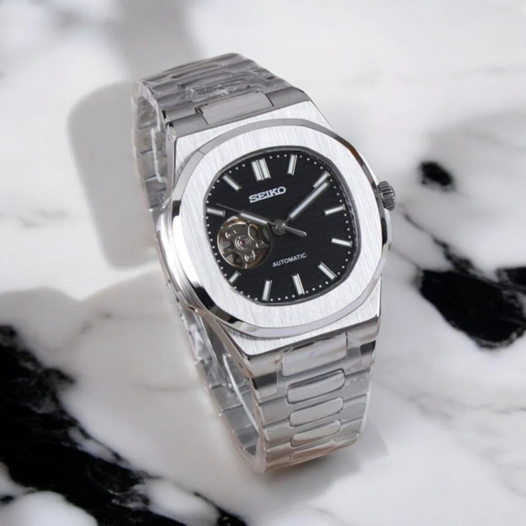 Left angled perspective of Seiko mod Nautilus black open heart displaying striped dial