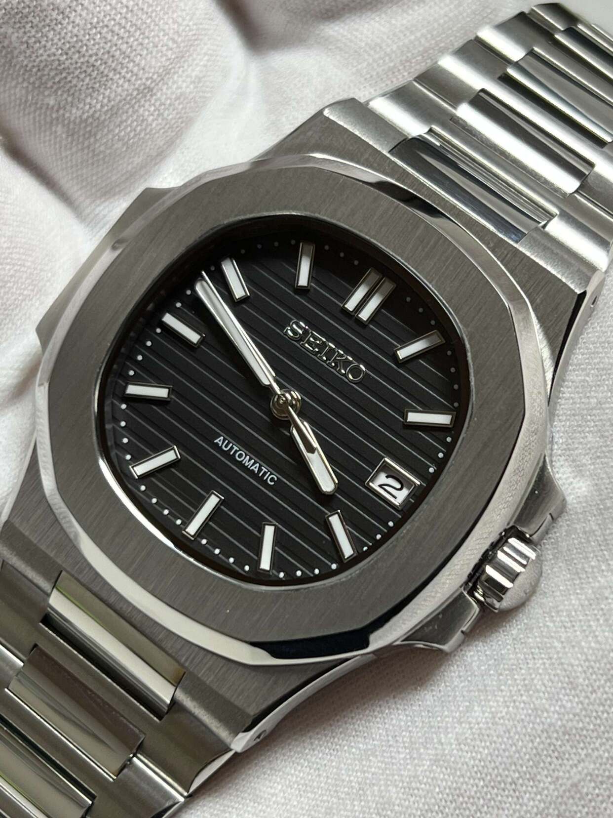 Top view of Seiko mod Nautilus black with integrated bracelet and brushed surfaces