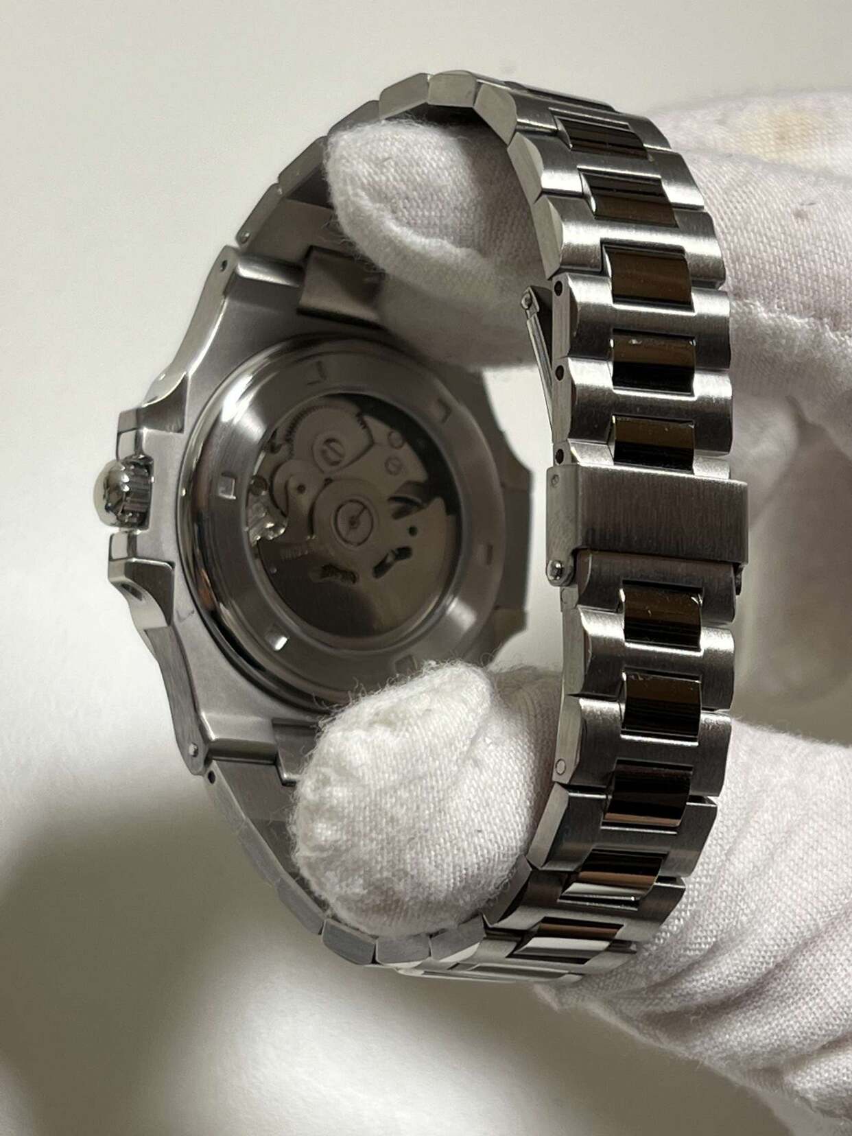 Open back of Seiko mod Nautilus black revealing NH35 rotor and mechanical parts