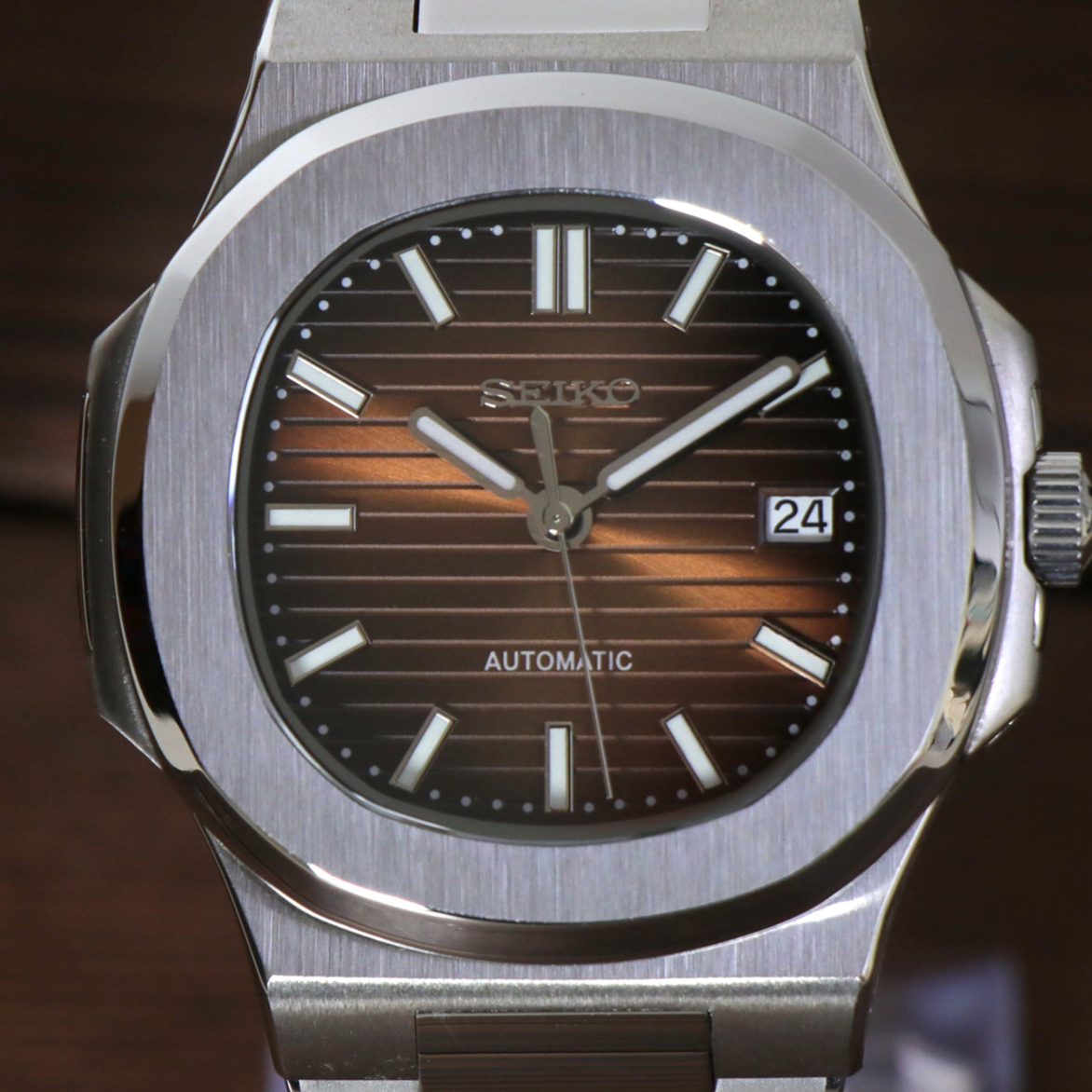 Close up on Seiko mod Nautilus brown dial with horizontal texture and sunburst effect