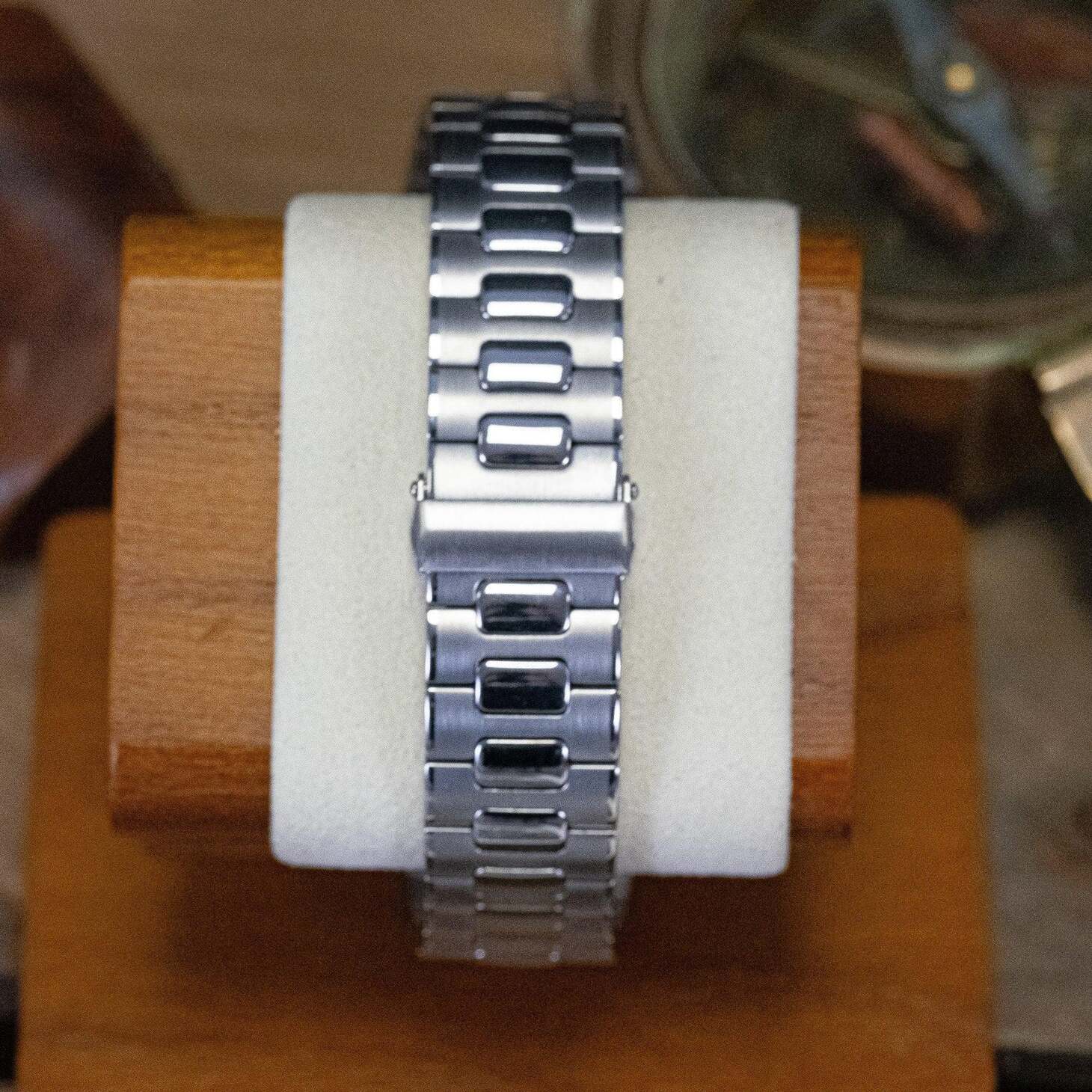 Bracelet of Seiko mod Nautilus minimalist edition showing polished and brushed stainless steel links on wooden stand
