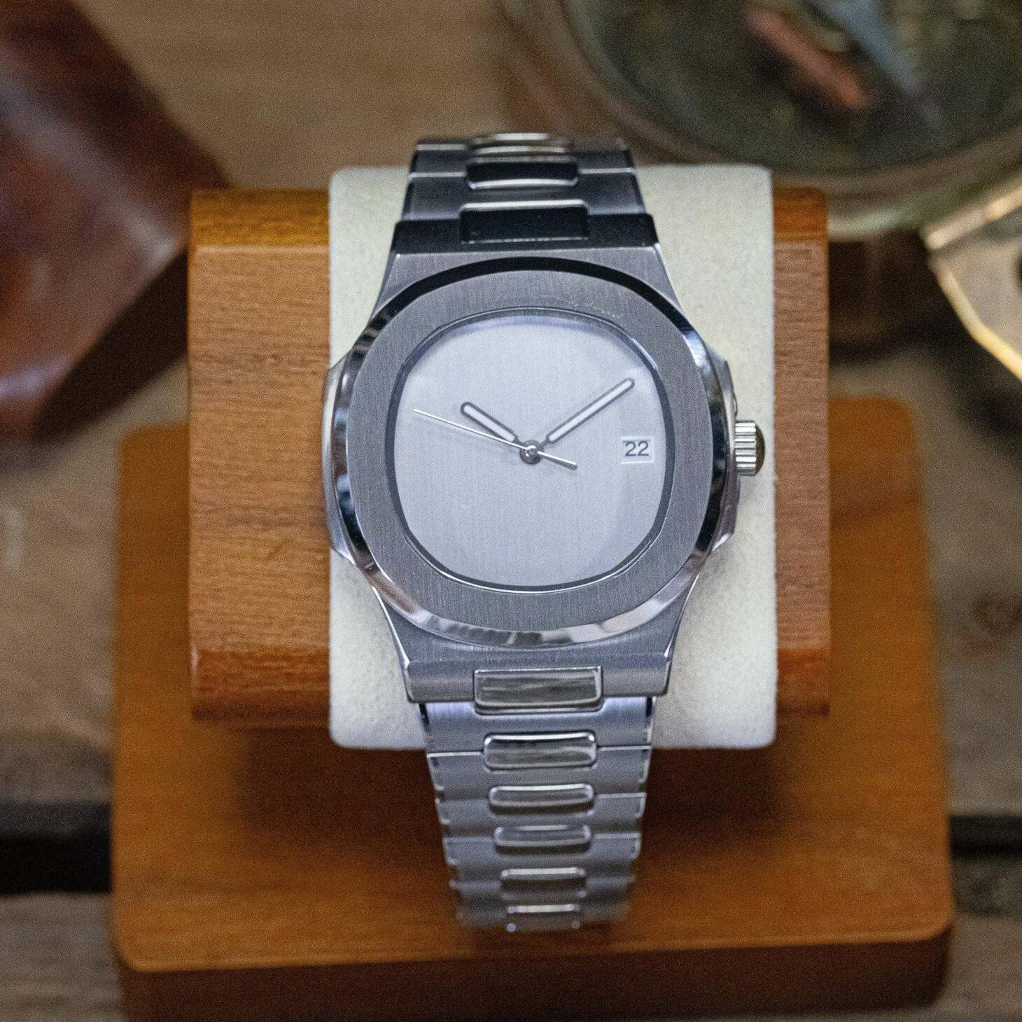 Front view of Seiko mod Nautilus minimalist watch displayed on cushion stand highlighting clean design