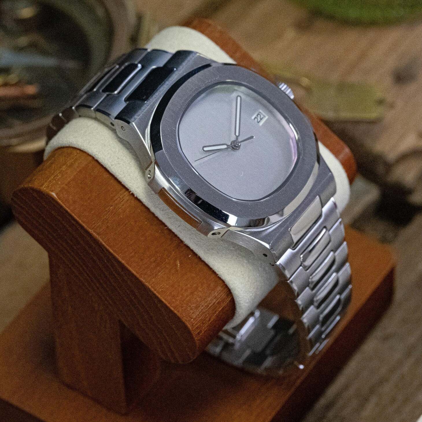 Left angled view of Seiko mod Nautilus minimalist emphasizing slim case profile and integrated bracelet