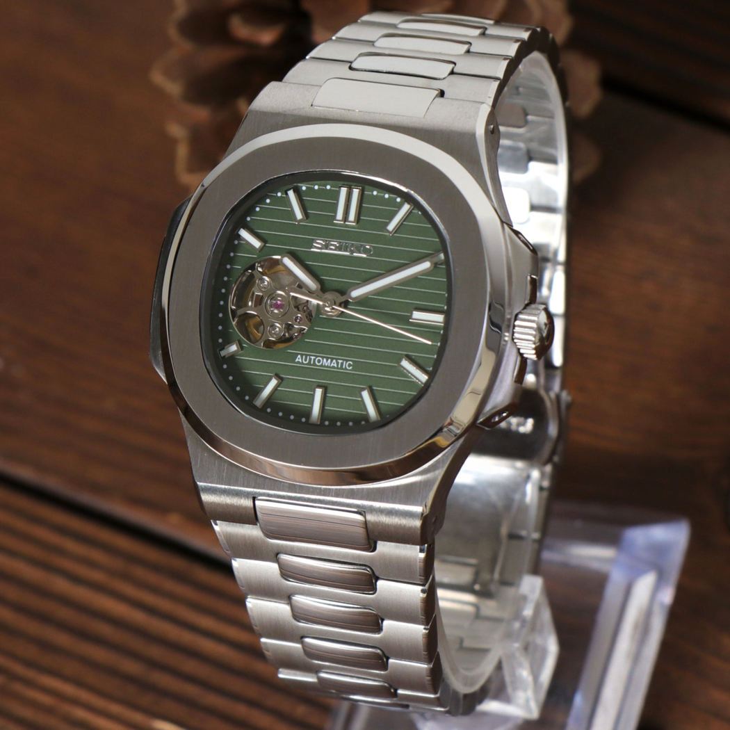 Three quarter view of Seiko mod Nautilus olive green open heart highlighting dial texture and case finish