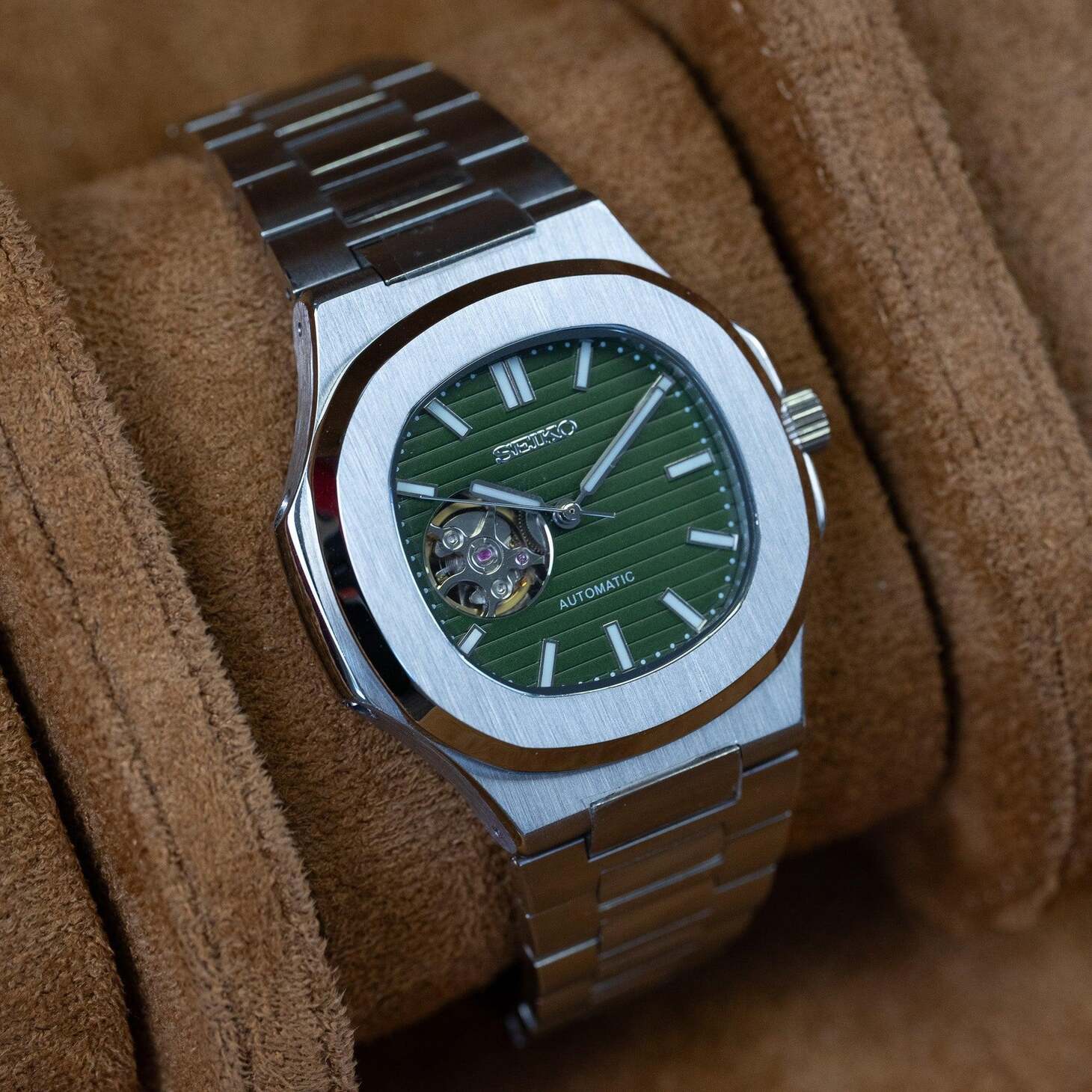 Left angled view of Seiko mod Nautilus olive green open heart emphasizing polished bezel and markers