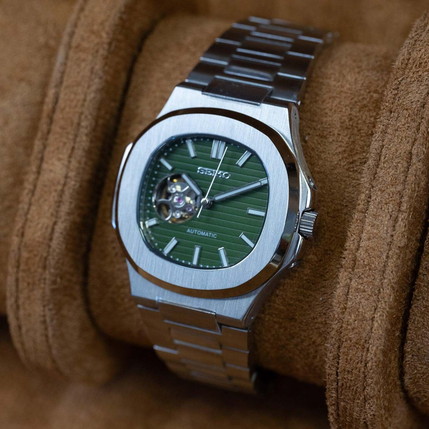 Right angled view of Seiko mod Nautilus olive green open heart capturing depth and dial reflection