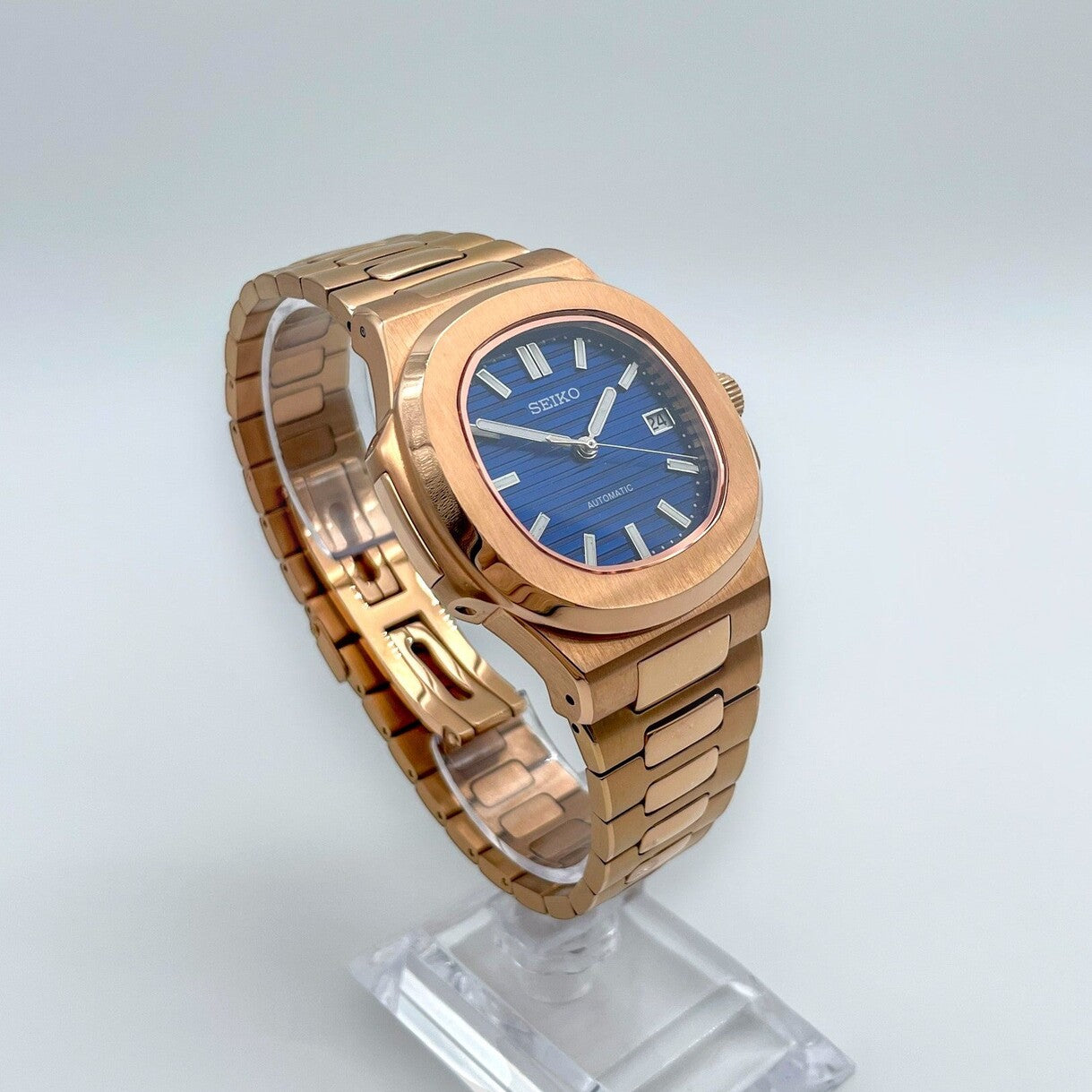 Left angled shot of Seiko mod Nautilus rose gold royal blue edition capturing light reflection on case and bezel