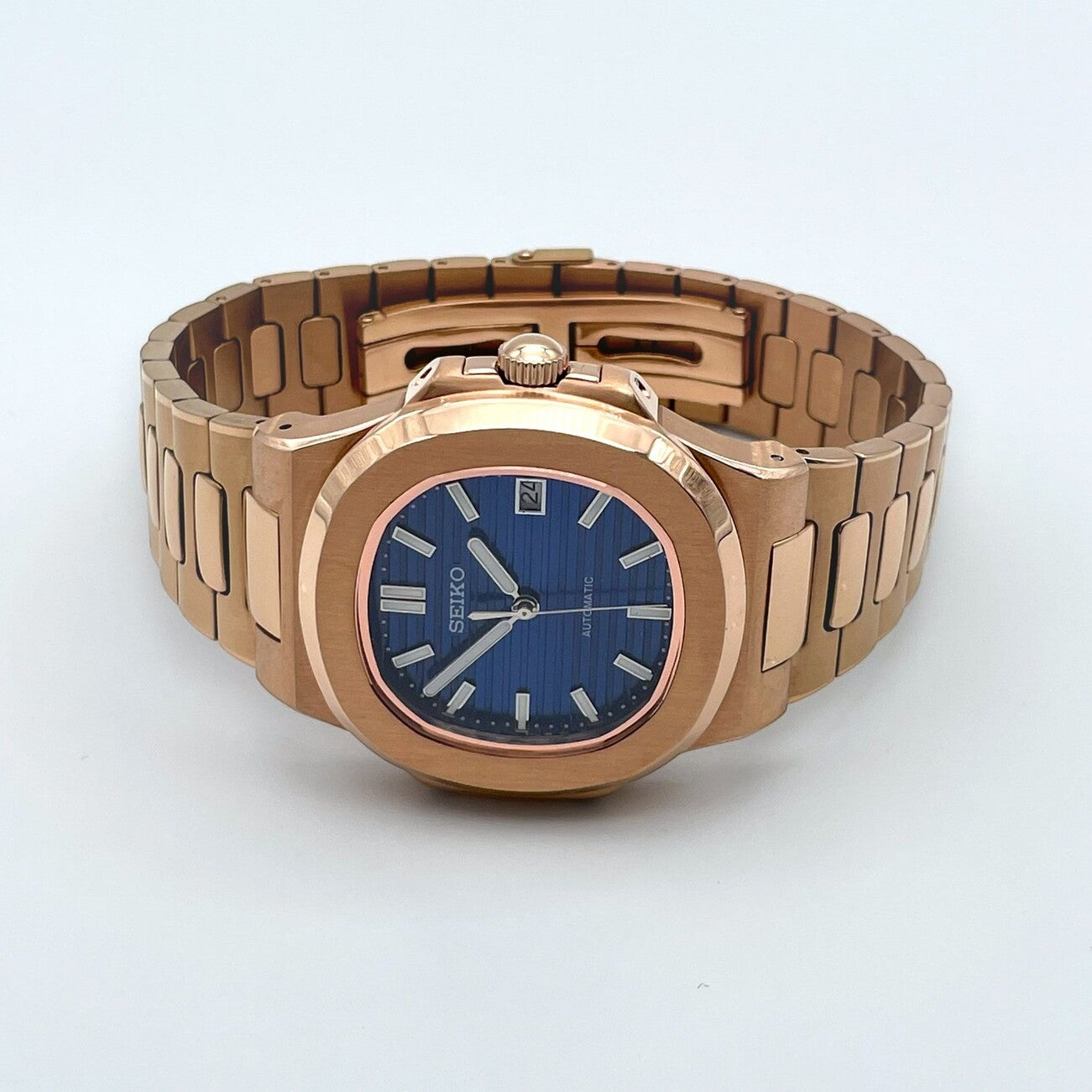 Table shot of Seiko mod Nautilus rose gold royal blue edition with vibrant blue dial under soft lighting