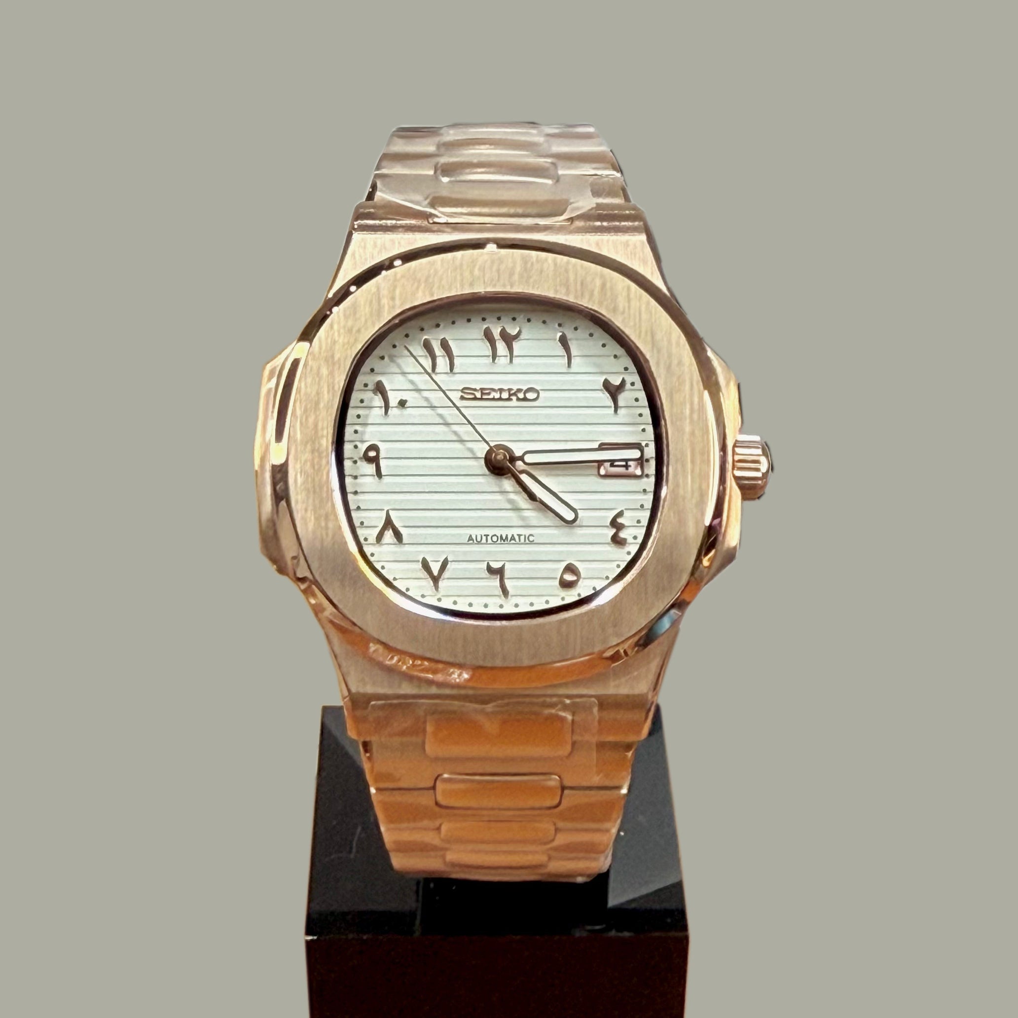 Front view of Seiko mod Nautilus rose gold white Arabic edition showcasing brushed case and Eastern Arabic numerals on white dial