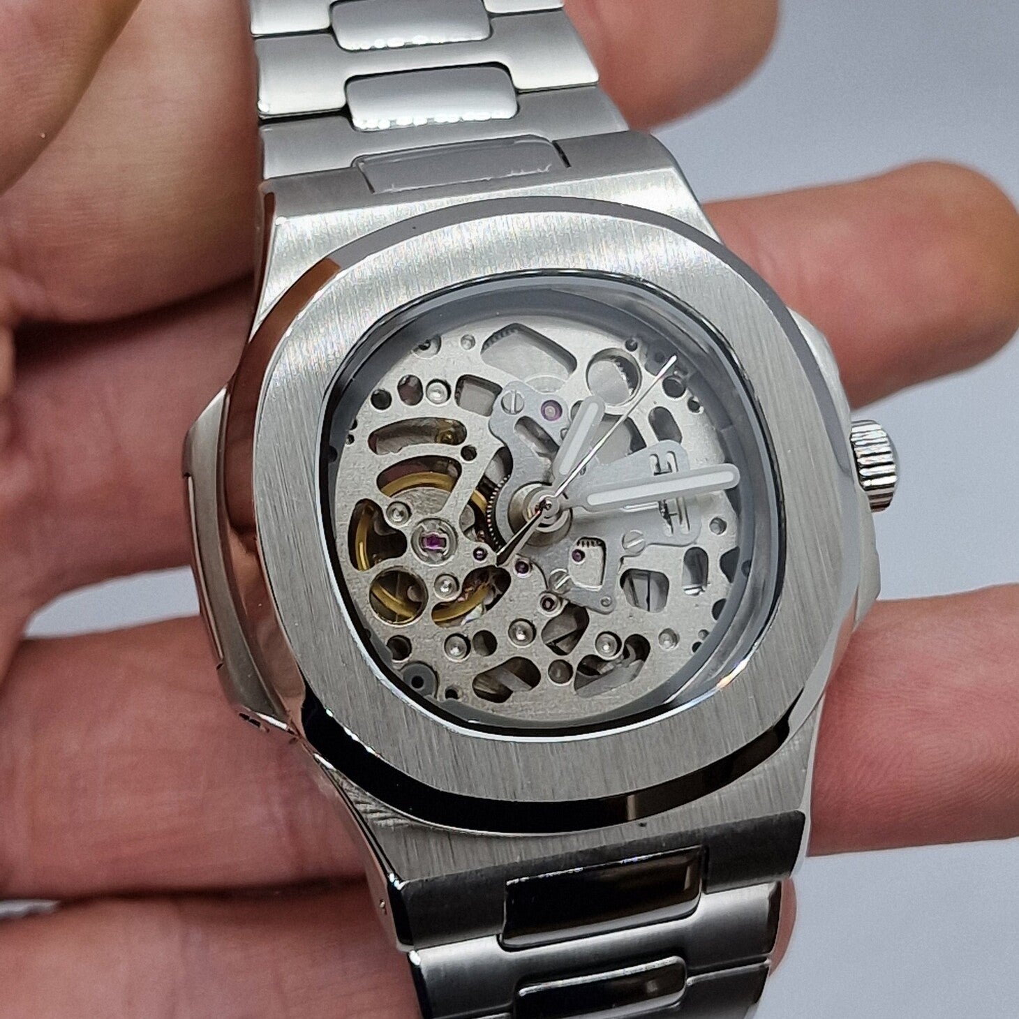 Left three quarter angle Seiko Mod Nautilus Skeleton focusing on brushed case and open dial