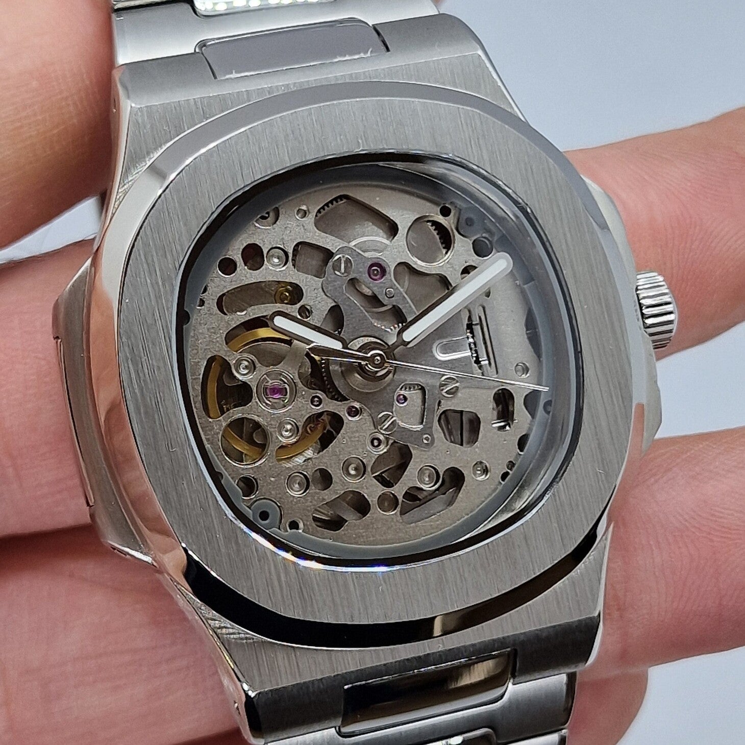 Left angled close up Seiko Mod Nautilus Skeleton highlighting skeleton dial and polished bezel