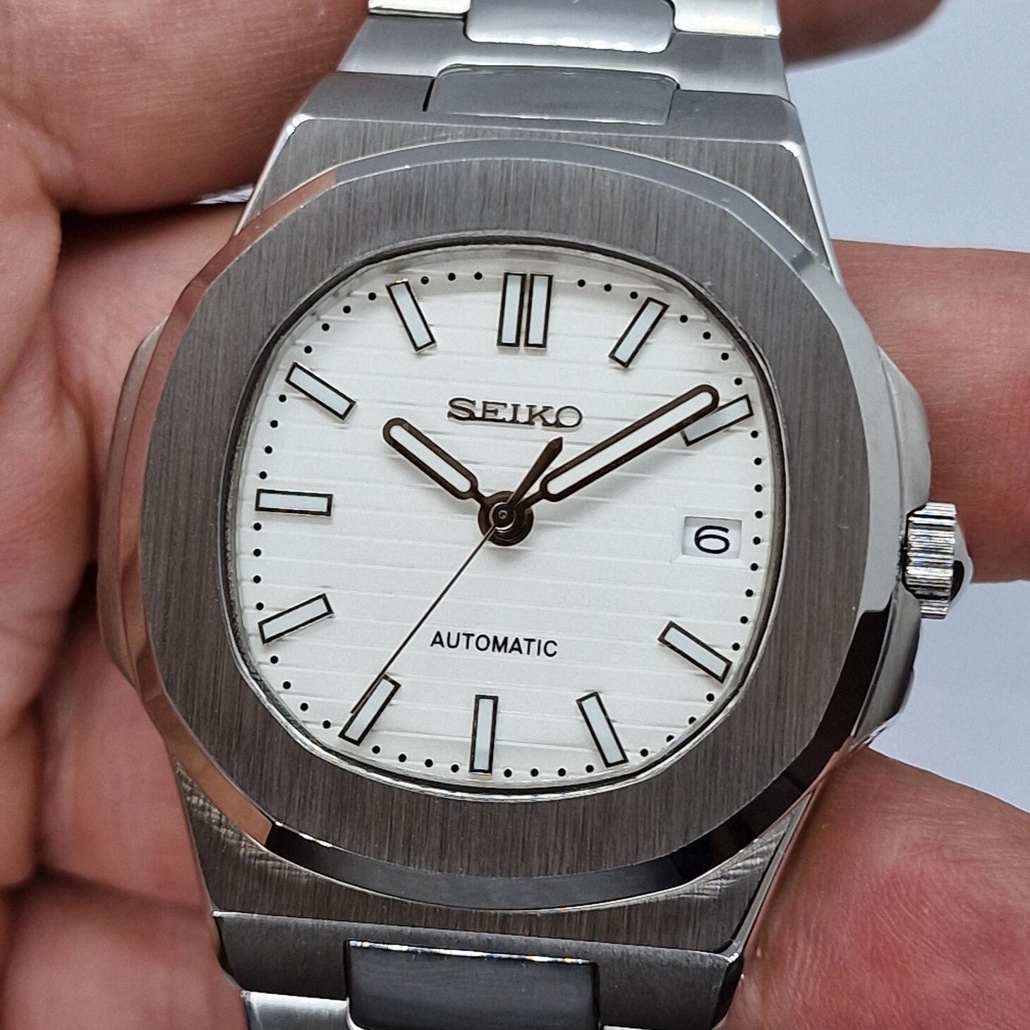 Front view Seiko Mod Nautilus White showing clean white dial and brushed steel case