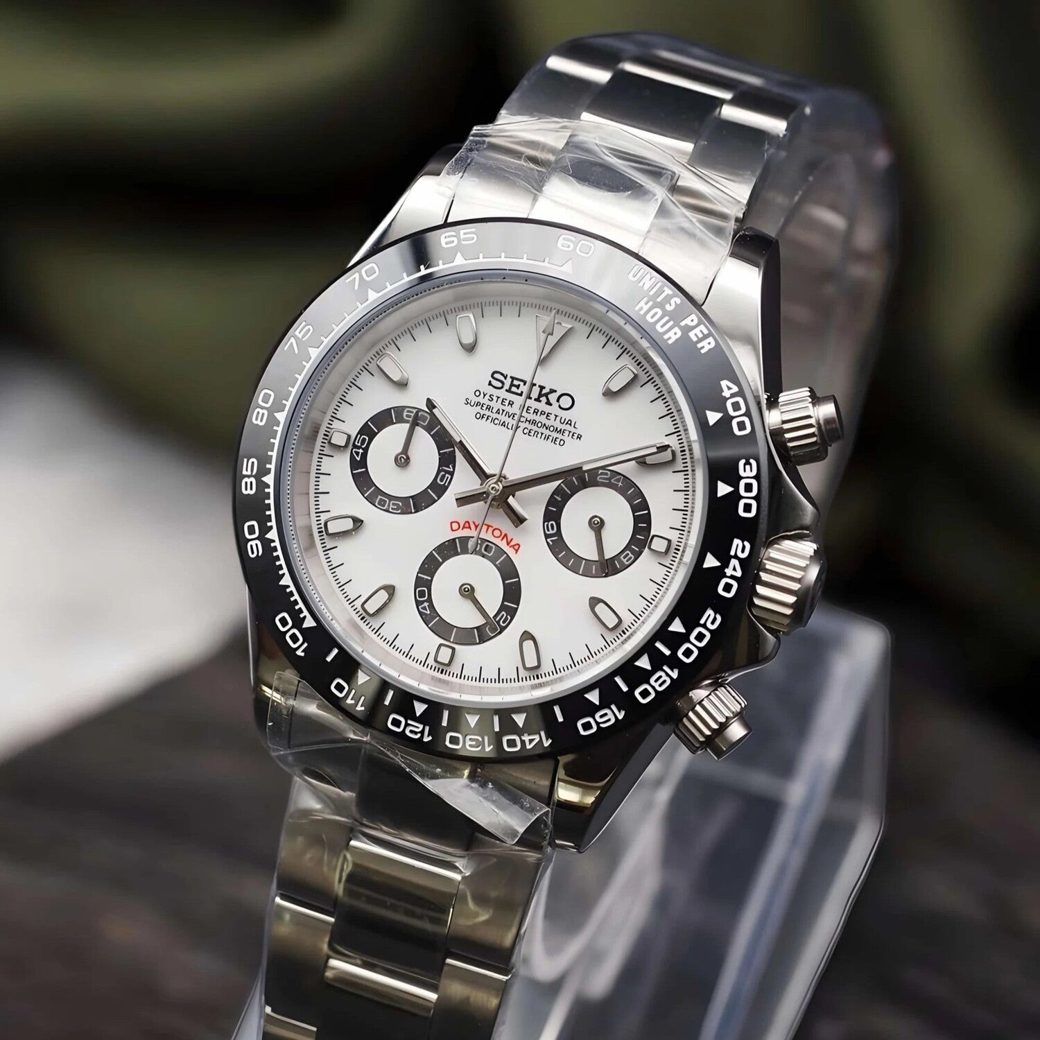 Angled view of Seiko Mod Daytona Panda with crisp white dial, black subdials, ceramic bezel and polished steel bracelet.