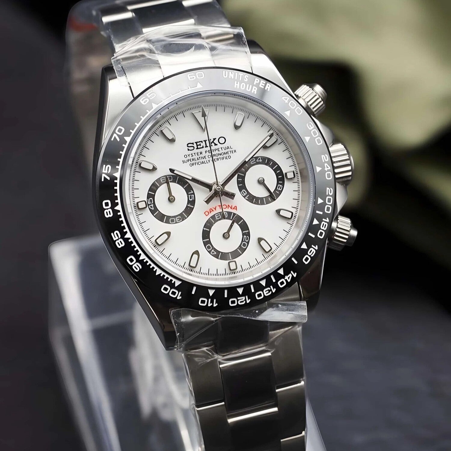 Angled view of Seiko Mod Daytona Panda with white dial, black subdials and ceramic tachymeter bezel on steel bracelet.