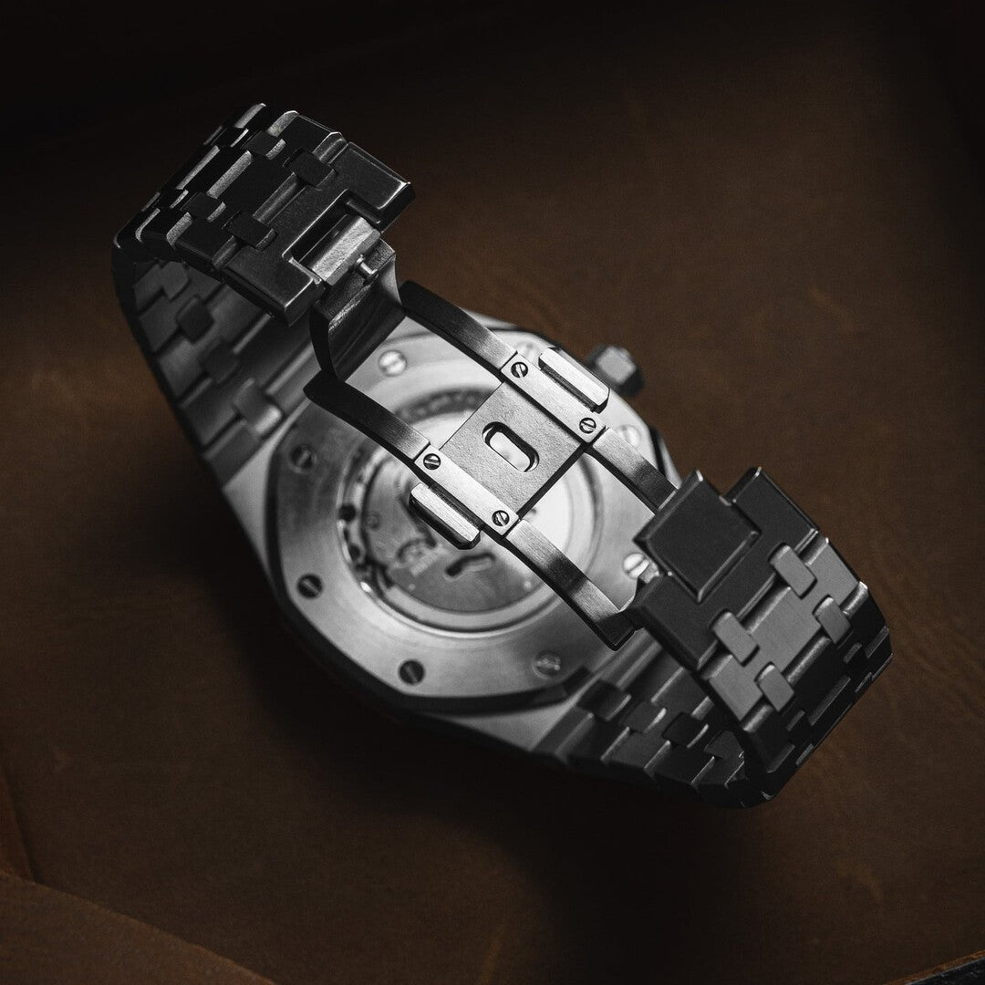 Bottom view of the Seiko Mod Royal Oak showcasing the open clasp and integrated stainless steel bracelet, with the exhibition caseback revealing the automatic movement.