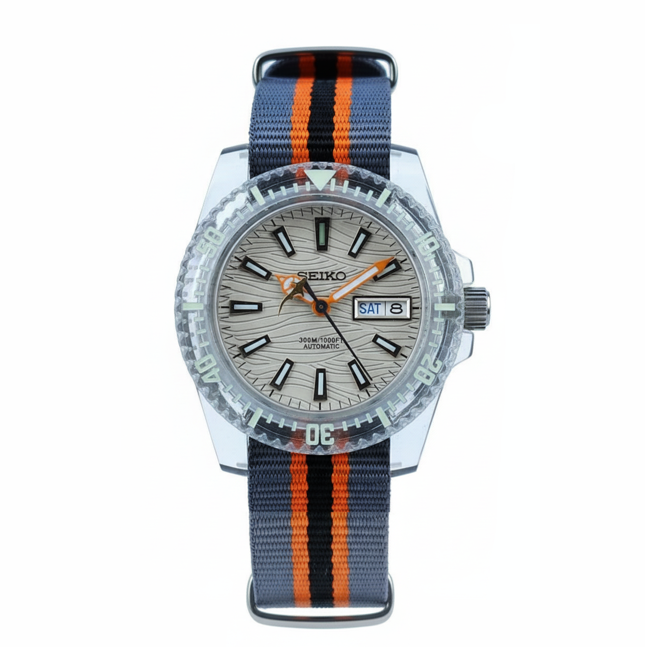 Shark Plex Creme Taucheruhr mit cremefarbenem Zifferblatt, markanten Leuchtzeigern, Plexiglas, drehbarer Taucherlünette und sportlichem NATO Armband in Grau mit orange-schwarzem Streifenmuster.