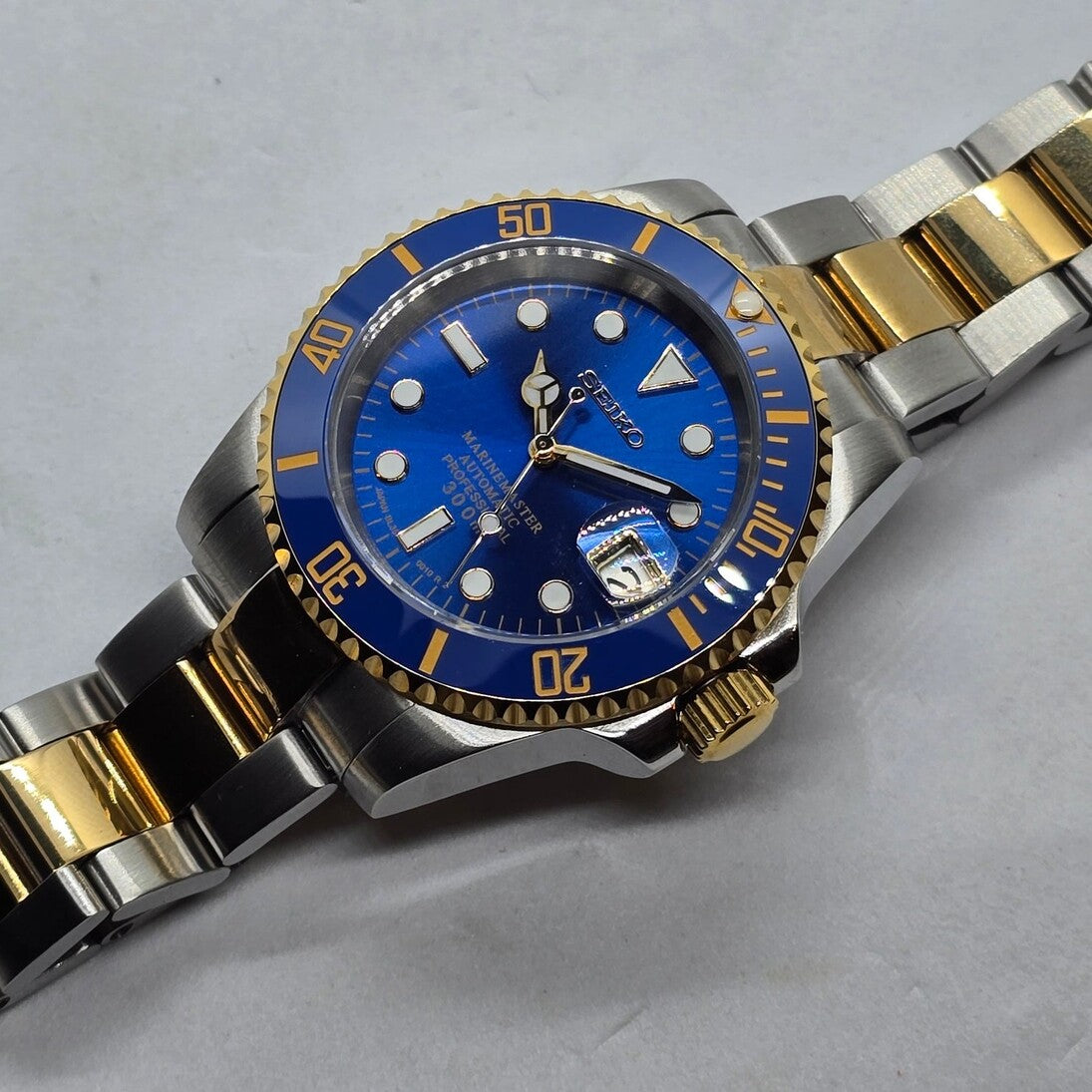 Right top angled view Seiko Mod Submariner blue dial highlighting crown and lug polish