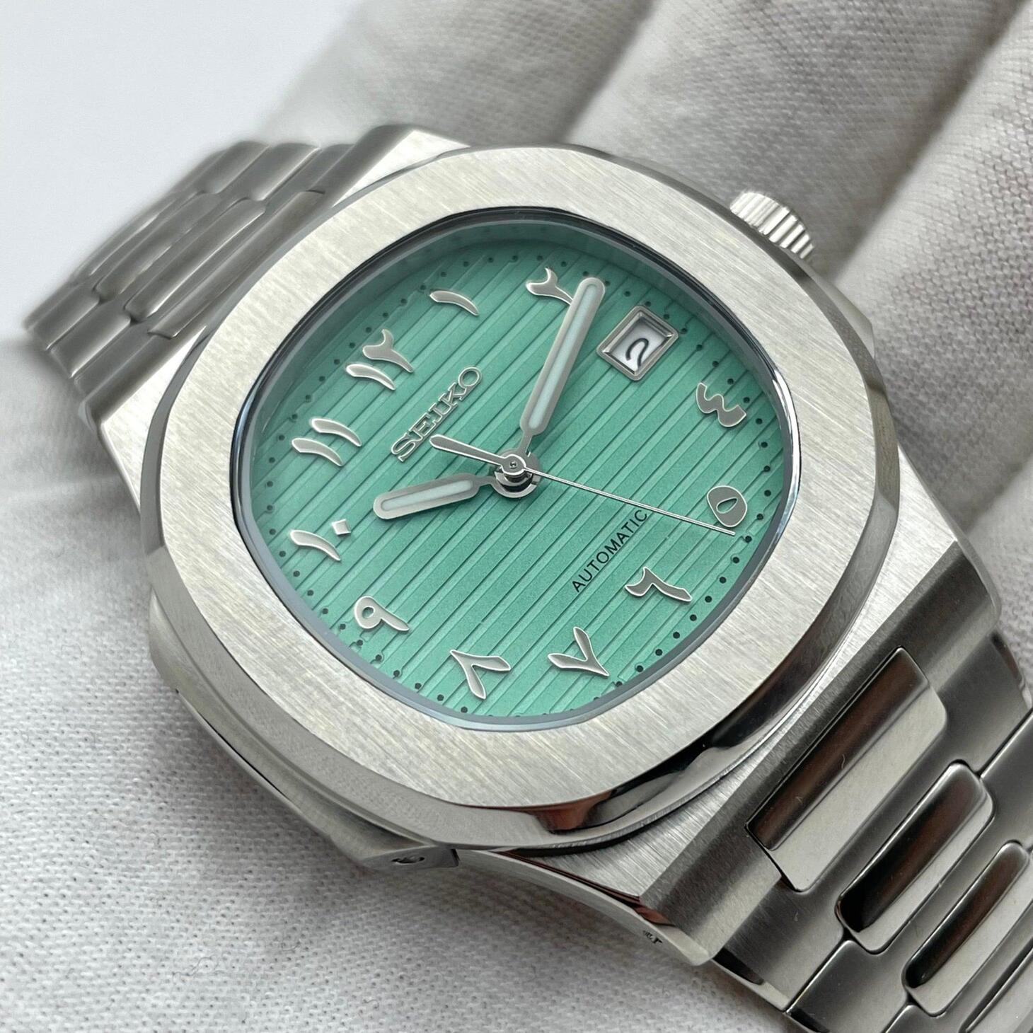 Left angle Seiko Mod Nautilus Tiffany Arabic showing brushed case and dial reflections