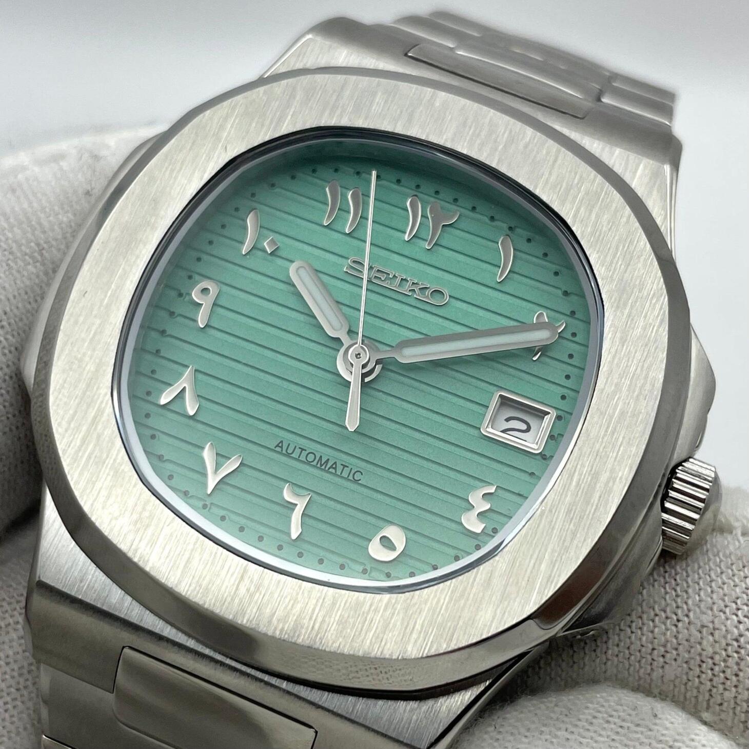 Right angle Seiko Mod Nautilus Tiffany Arabic focusing on crown and mint green dial contrast