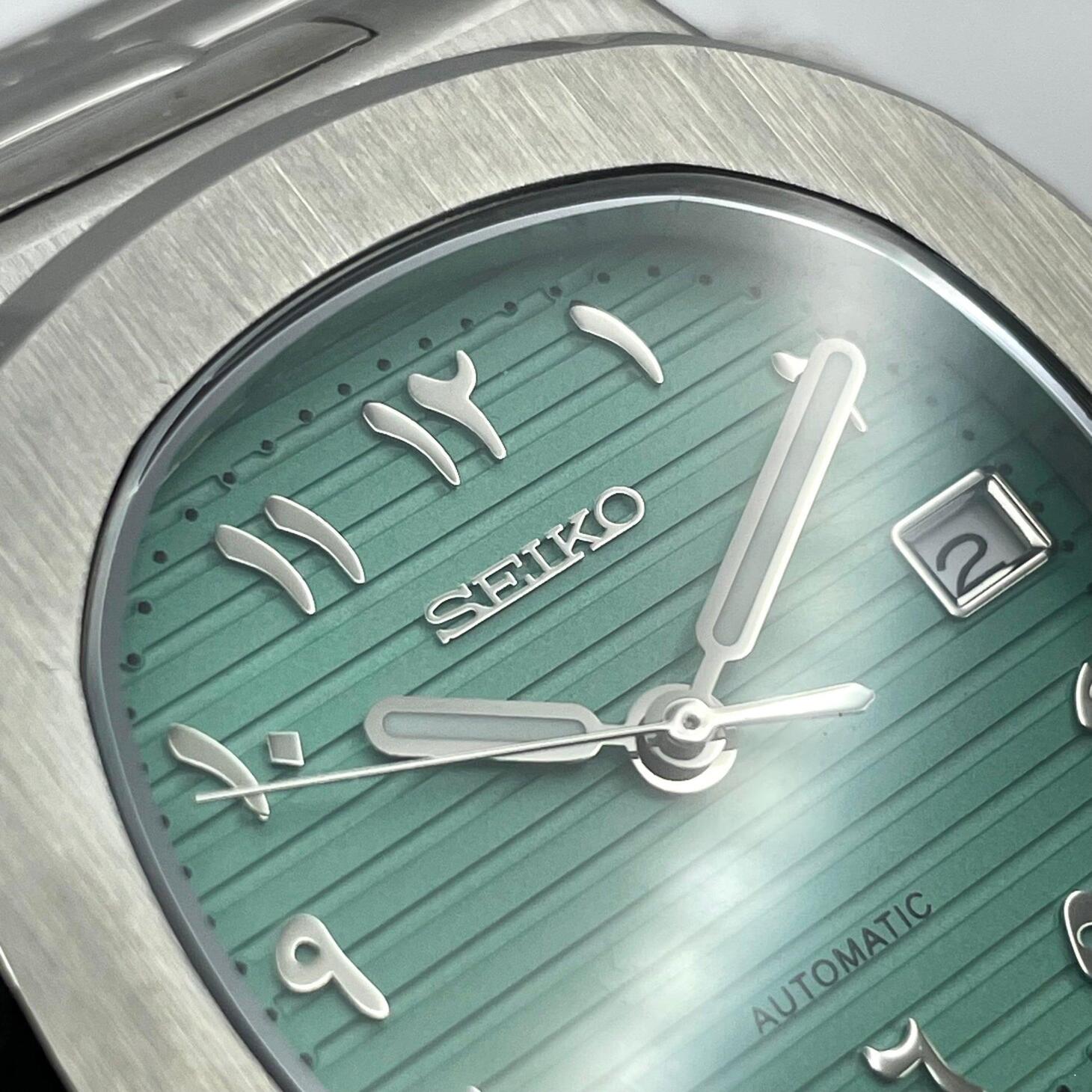 Close up Seiko Mod Nautilus Tiffany Arabic showing SEIKO logo and Arabic numerals detail