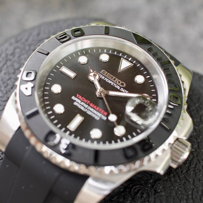 Angled bottom view Seiko Mod Yachtmaster black dial on rubber strap with ceramic bezel