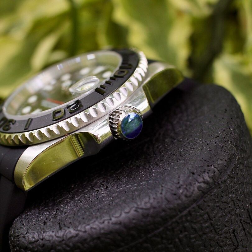 Crown close up Seiko Mod Yachtmaster highlighting blue cabochon and polished case edge