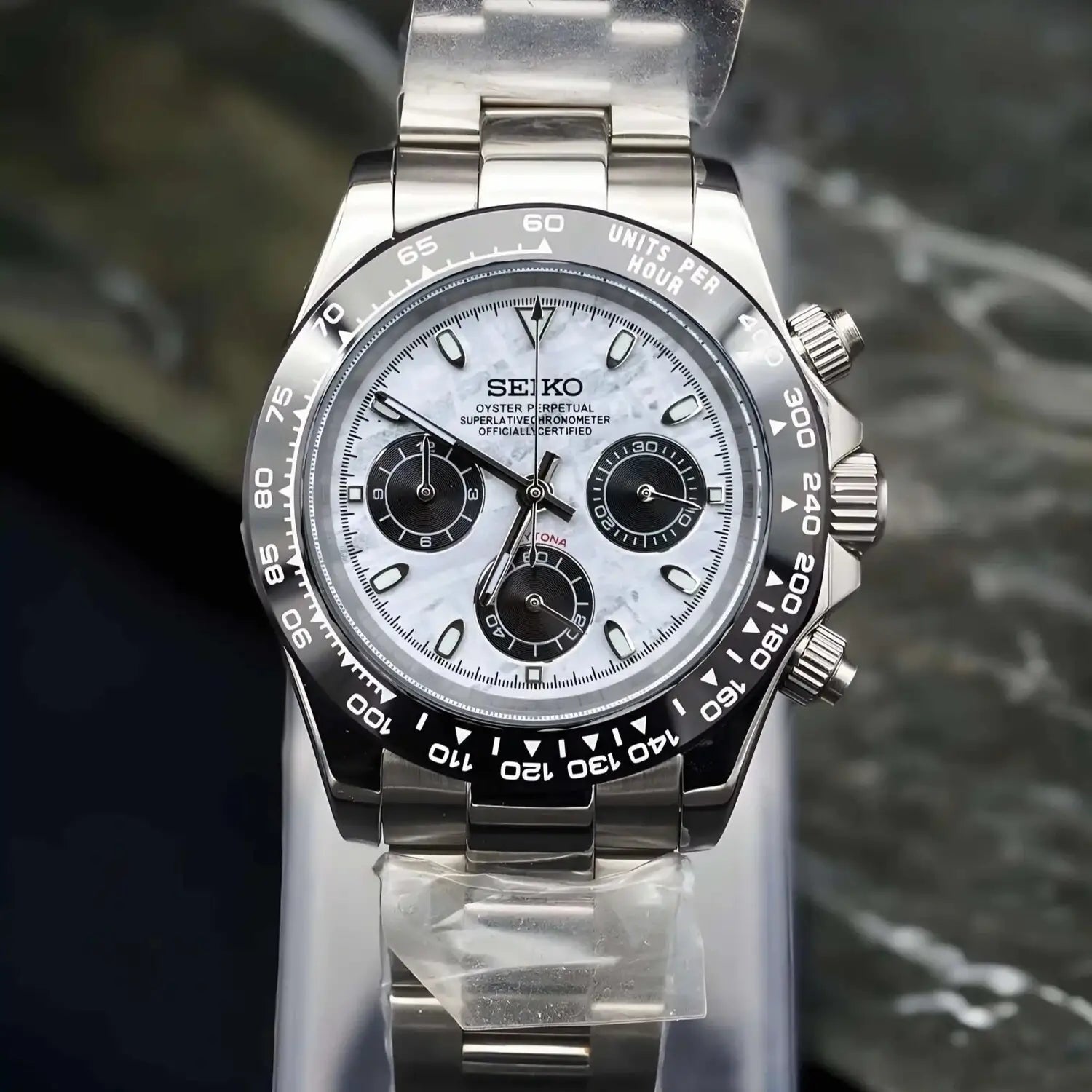 Front view of the Seiko Mod Daytona Meteorite. Watch with black tachymeter bezel, white gray meteorite dial, and stainless steel bracelet. High quality Daytona inspired Seiko model