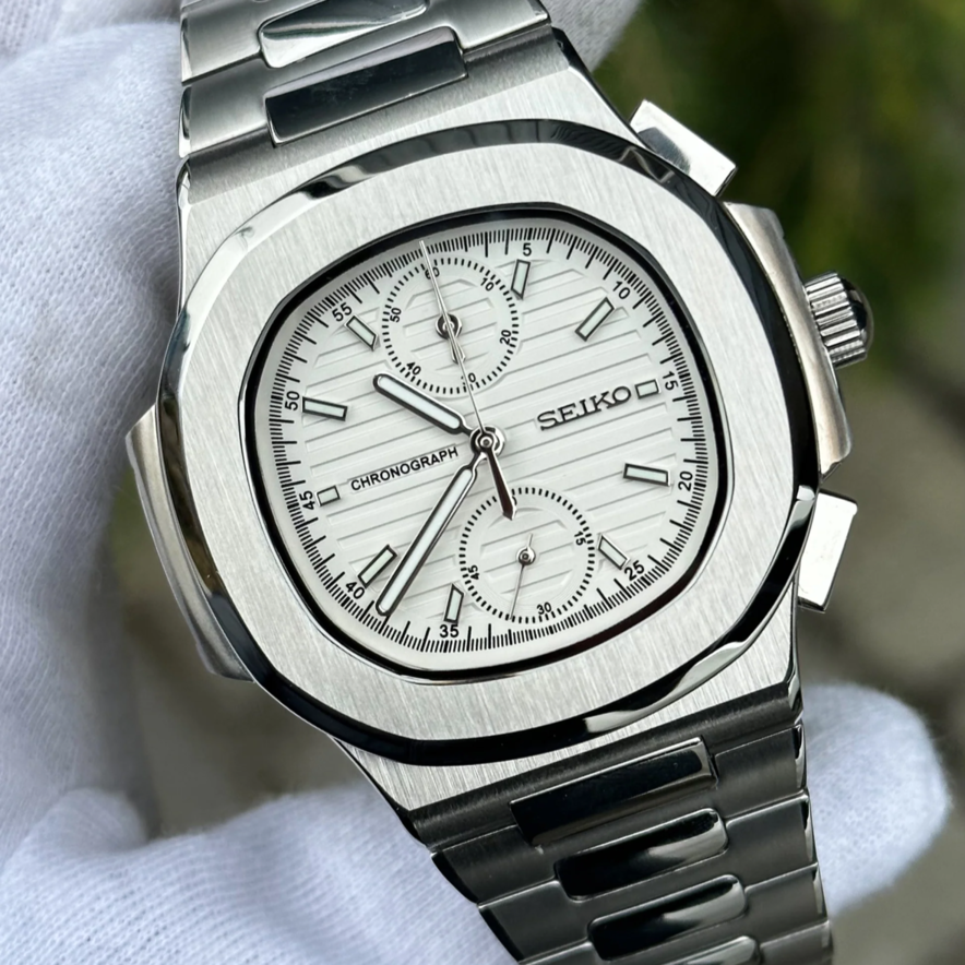 Angled close up of Seiko mod Nautilus chronograph white highlighting dial texture and subdials