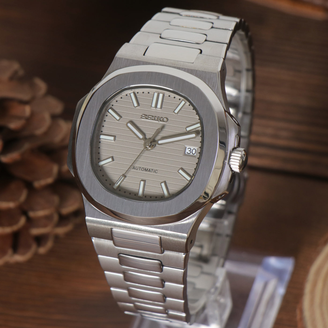 Right angled perspective of Seiko mod Nautilus cream emphasizing dial texture and brushed bezel