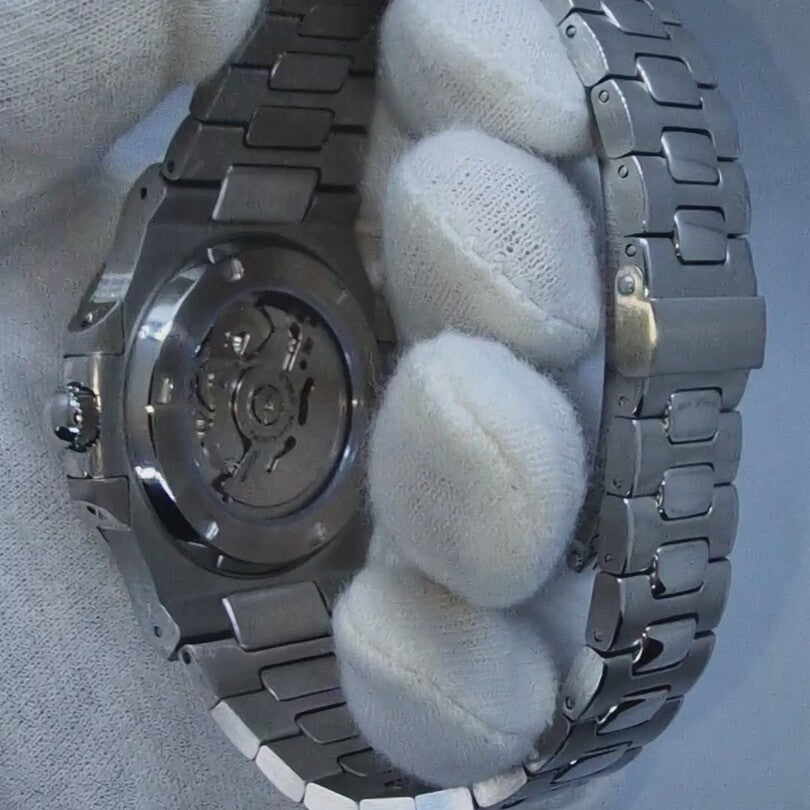 Back close up of Seiko Mod Nautilus Skeleton revealing transparent case back with rotor and engraved markings.