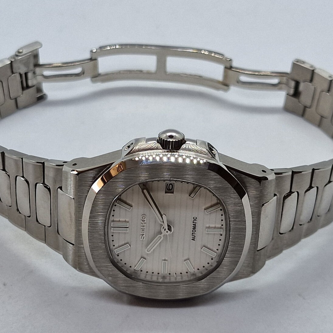 Horizontal view Seiko Mod Nautilus White highlighting case curvature and crown detail