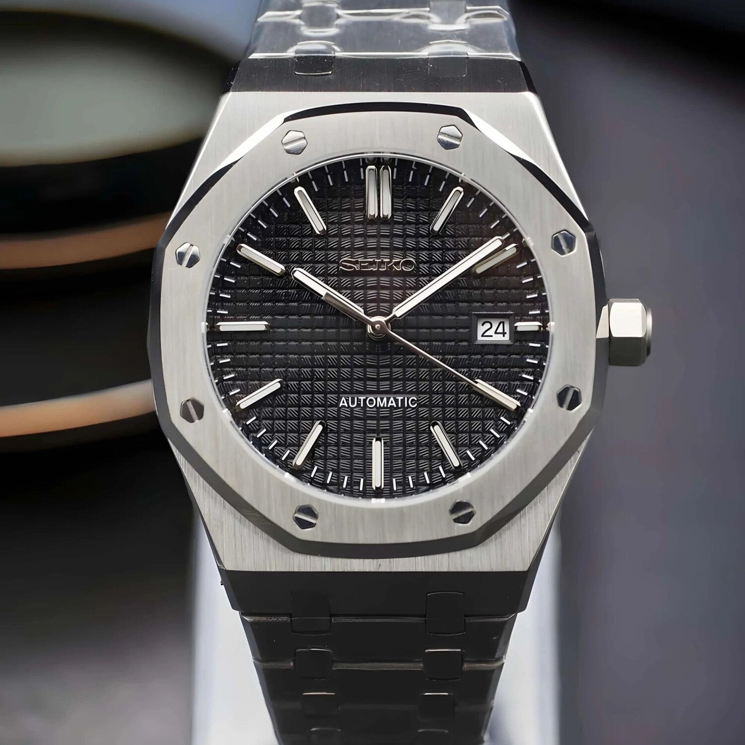 Front view of the Seiko Mod Royal Oak automatic watch with black textured dial, brushed steel bracelet, and date indicator at 3 o’clock